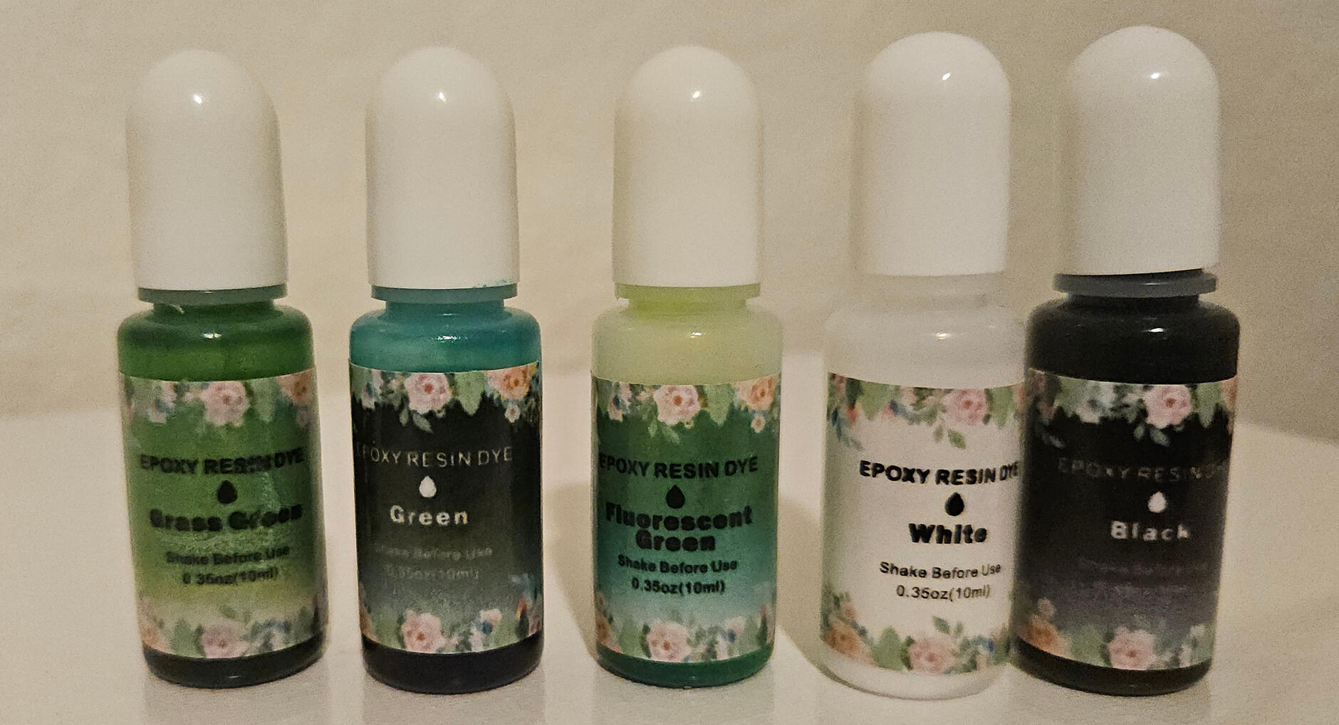 Grass green, green, fluorescent green, white and black. Grass green, green, fluorescent green, white and black dyes in a row.