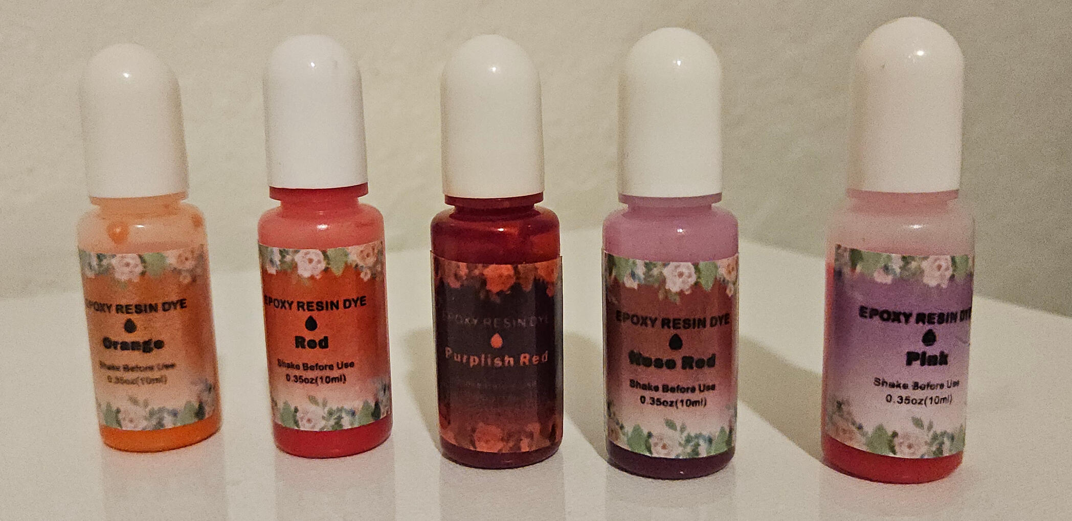 Orange, red, purplish red, rose red, and pink dyes in a row.